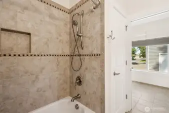 Tiled walls in second ensuite bathroom with linen closet