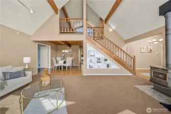 Upper loft open to below and offers full bath and separate bar sink
