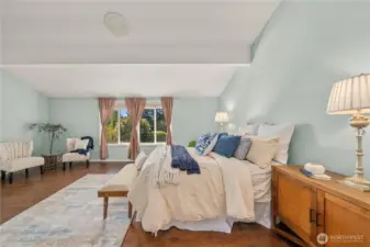 Impressive primary suite with vaulted ceilings