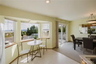 Breakfast nook with partial view of the dining room and deck.