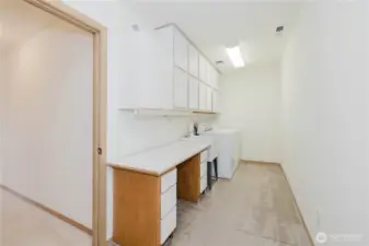 The laundry room is very spacious, has a sink and plenty of counter and storage space.