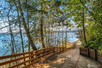 Looking down the paver path to the beach. This is a trail that is shared with the neighbor to the north. There is an easement in place that allows the subject property owner access. The dock  itself is located on the subject property. The two owners share in maintenance of the trail and the dock. Agreements are on Title.