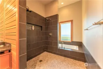 The paired shower is gracious and with water radiant heat in the floor extending under the shower there is comfort to spare on the way to and from the view jetted tub!