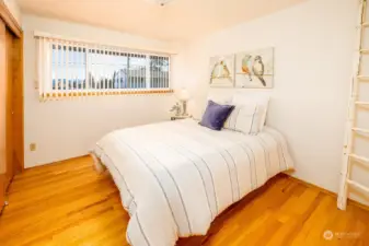 Second of three main floor bedrooms. This view faces east towards the mountains.