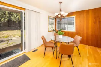 The slider to the back yard and patio is easily accessed between the kitchen and dining room spaces.