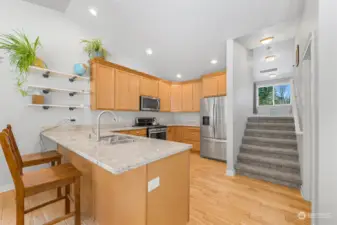 Big kitchen with stairs up to bonus room