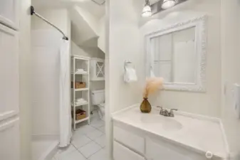 Bright bathroom just off the lower-level rec/bonus room with a shower and tile floors.