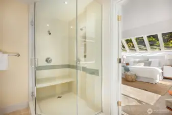 Spacious shower with dual showerheads, ceramic tile, and glass enclosure!