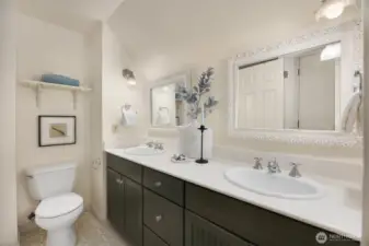 Full bathroom conveniently located near both bedrooms, featuring dual sinks and generous storage.