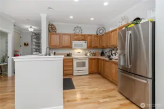 View of kitchen from laundry room. Half bath and entry way seen to the left.