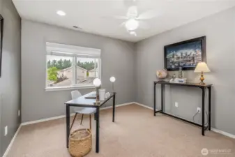 First bedroom at the top of the stairs, staged as an office but plenty large enough for a queen size bed.