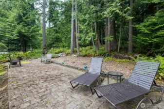 Large patio nestled in the treeline.