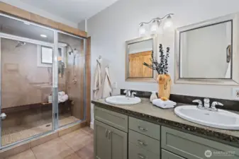 Two sinks; large shower that is also a steam shower
