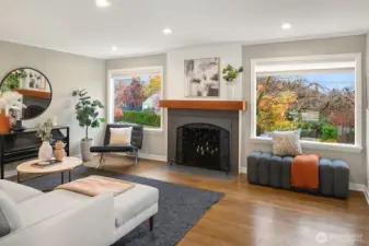 The living room is graced with a lovely wood-mantled fireplace and east facing picture windows