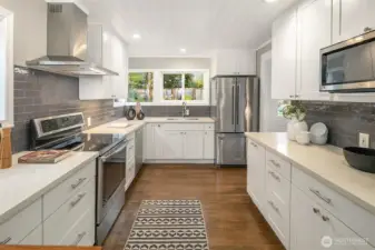 The kitchen has loads of cabinets and counterspace and a functional layout that makes cooking a joy.