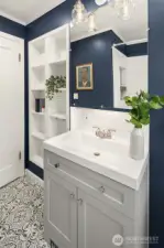 This charming bathroom also has the original shiplap ceiling and built-ins for storage.