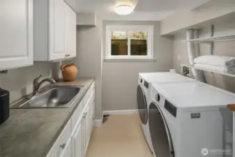 Laundry room with sink and abundant cabinet and counter space.  Could become a second kitchen?