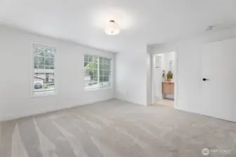 Primary bedroom. New plush carpet, paint and lighting througout the upper level.