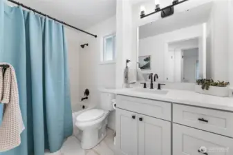 Updated full bathroom with new floor tile, vanity, counter top as well as new shower fixture and toilet.