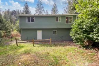 The house-flipper, in me, would add a slider off of the kitchen and build a deck with stairs down to the yard. I'd do the same with the lower window off of the laundry room, but with French doors.