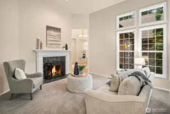 Formal living room with fireplace with gas starter.  Oversized, south facing windows flood this room with sunshine.