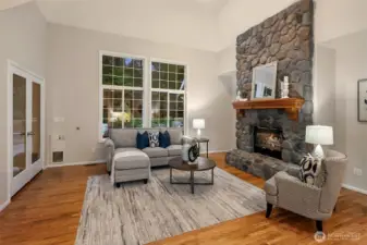 Hardwood floors throughout casual living space and tall windows let the sunshine in.