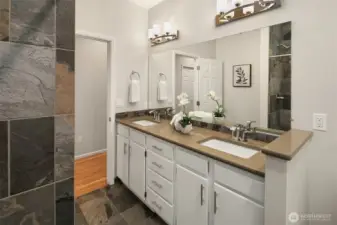 Remodeled hall bathroom with dual vanities and quartz countertops.