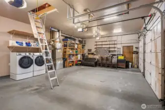 790sf 3-car garage with no center post!  Tons of built in storage. Extra tall garage doors.  Drop down ladder to huge attic storage space.