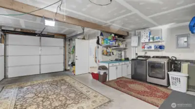 Spacious garage with convenient laundry area and extra storage.