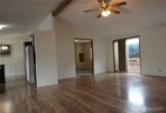 Walk into a large open concept living area with vaulted ceilings.