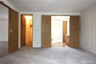 Primary suite with double doors leading into the room and double doors leading into the bathroom. Walk in closet.