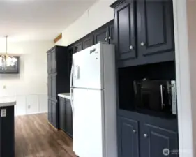 Kitchen has plenty of cabinets for storage.