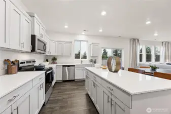 Lot's of cabinetry and storage in the kitchen and island. Actual home is under construction and colors, materials, and finishes may vary. See site agent for details.