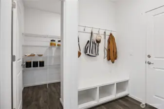 Drop zone off garage convenient for shoes, jackets, and coats. Photo is representational. Actual home is under construction and colors, materials, and finishes may vary. See site agent for details.