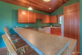 Fully appointed kitchen in guest house with bar seating.