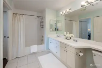 Full bathroom features a laundry closet and access to the 2nd bedroom.