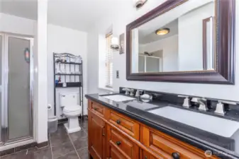 Primary bathroom has 3/4 size shower (only) with 2 sinks. Updated with brushed nickel faucets and quartz countertops. Closet is to the left and IS surprisingly small for a primary bedroom.