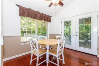 Kitchen eating area with french doors to covered patio in background