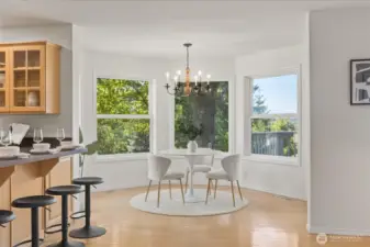 Charming eating space with gleaming hardwood floors and French doors that open to a large deck—all framing peaceful views of the yard and stunning evening sunsets.