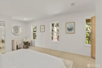 The primary suite includes a cozy nook—ideal for a small sitting area, compact desk, or exercise space—offering a versatile spot