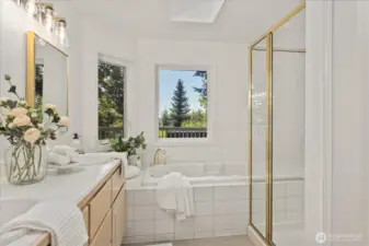 Enjoy the jetted tub surrounded by private windows that frame tranquil views, allowing you to soak in the scenery while enjoying peaceful natural light and a sense of privacy.