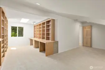 The bonus room features built-in storage and a dedicated desk area, providing ample space for a living or TV zone, a pool table, and a separate office nook—perfect for work, play, and relaxation all in one.