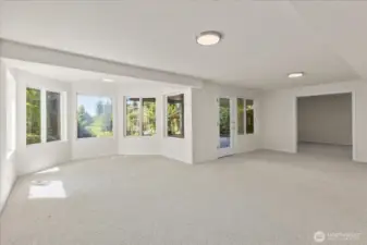 The lower level includes space for a second dining area and rough-in plumbing for a second kitchen, providing excellent potential for an ADU or multi-generational living setup.