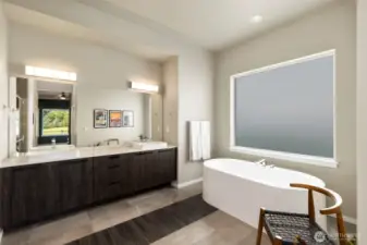 Primary bathroom with tile floors, soaking tub and quartz counters