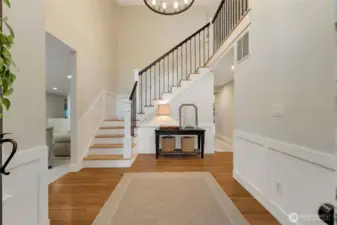 Entry way with refinished hardwoods. New carpet in 2023.