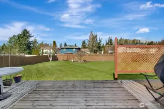 View of yard from rear deck looking north. Fully fenced back yard