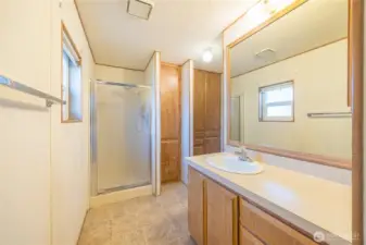 Large primary bathroom is large and features a shower and a separate water closet