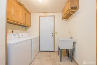 Separate laundry and utility room has its own door to the backyard.