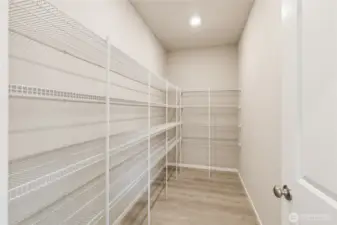 Large walk-in pantry! Photo is representational. Actual home is under construction and finishes and paint colors may vary. See site agent for details.