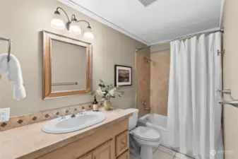 Full second bathroom with storage and tile surround above the tub!